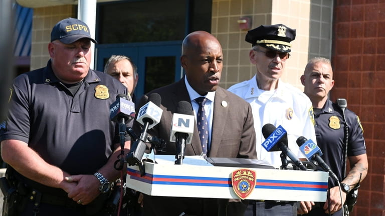 Suffolk County Police Commissioner Rodney K. Harrison briefs reporters about...