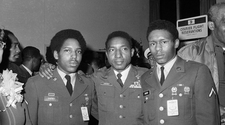 Former POW, Air Force Col. Fred Cherry, center, of Suffolk,...