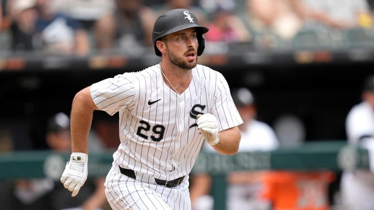 Chicago White Sox's Paul DeJong watches his RBI single during...