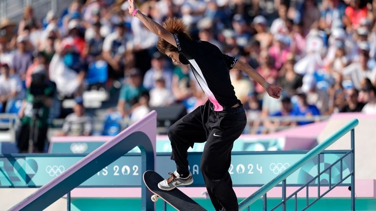 Yuto Horigome, of Japan, performs a trick during the men's...