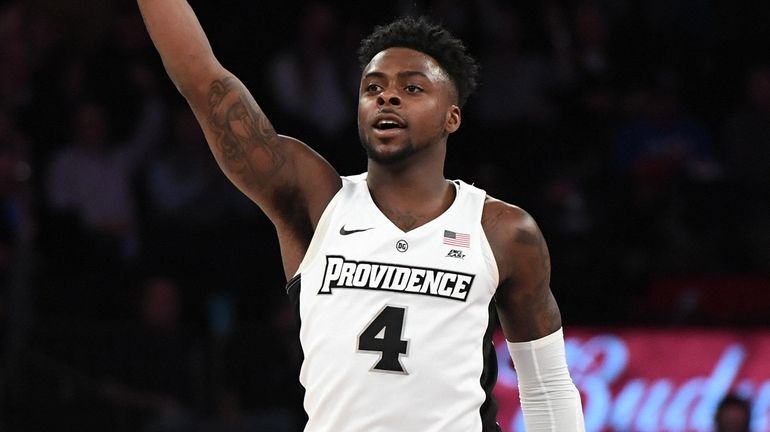 Providence guard Maliek White reacts after he sinks a three-point...