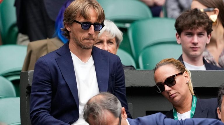 Luka Modric watches Carlos Alcaraz of Spain play Daniil Medvedev...