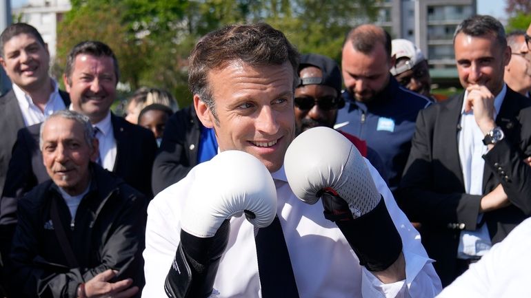 Centrist presidential candidate and French President Emmanuel Macron wears boxing...