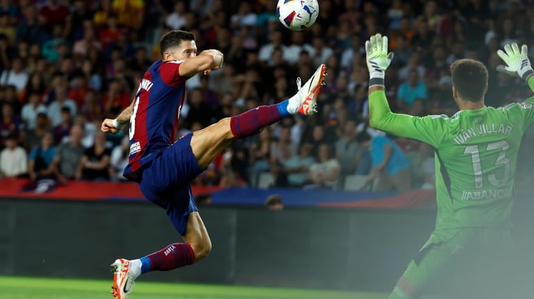 Barcelona's Robert Lewandowski scores his side's first goal during a...