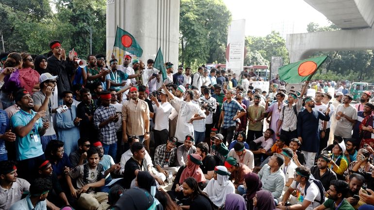 Students shout slogans as they demand the resignation of Bangladesh's...