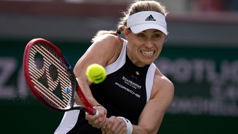 Angelique Kerber, of Germany, returns a shot against Veronika Kudermetova,...