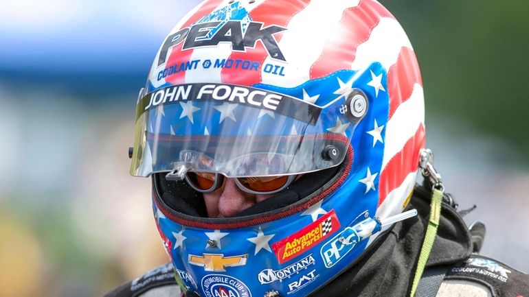 Funny Car driver John Force prepares to run in the...