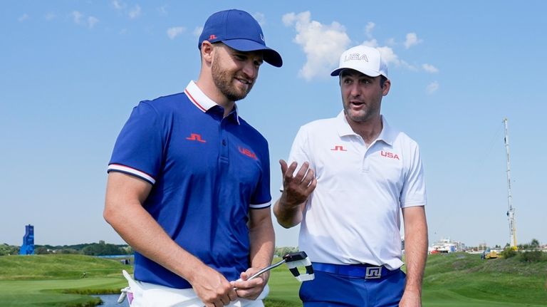 Wyndham Clark, left, and Scottie Scheffler, right, of the United...