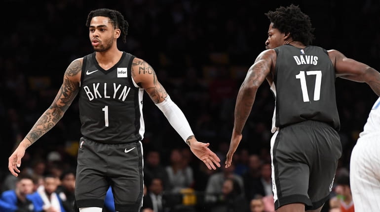 Nets guard D'Angelo Russell (1) slaps five with Ed Davis...