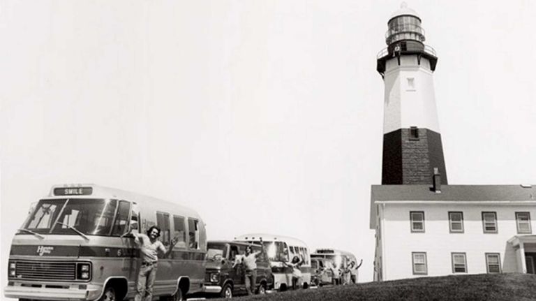 Drivers with Hampton Jitney stand next to some of the...