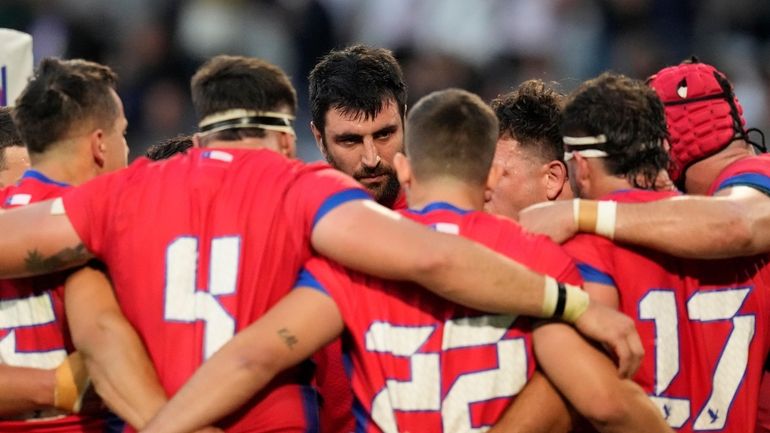 Chile's players huddle after the Rugby World Cup Pool D...