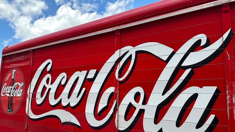 The Coca-Cola logo adorns the side of a delivery truck...