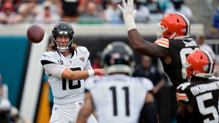 Jacksonville Jaguars quarterback Trevor Lawrence (16) throws a pass to...