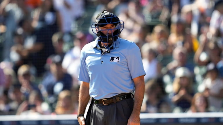 Home plate umpire Angel Hernandez watches in the fourth inning...