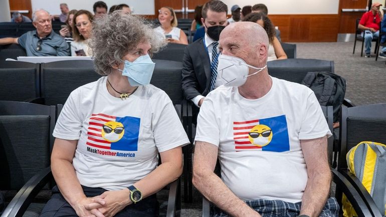 Angelique Corthals, left, of Stony Brook, and Philip Nolan, of Merrick, attend...