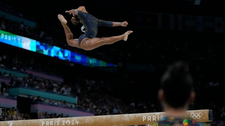 Rebeca Andrade, of Brazil, performs on the balance beam during...