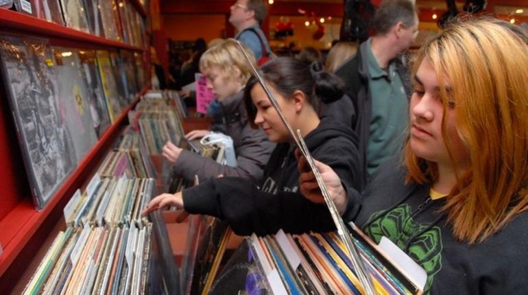 Customers sort through records at Looney Tunes in West Babylon.