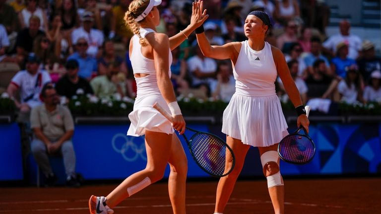 Mirra Andreeva and Diana Shnaider of Individual Neutral Athlete celebrate...