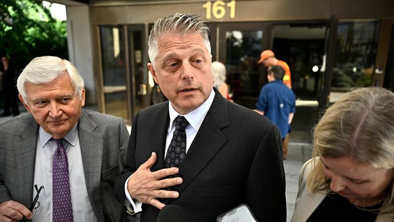 Former vice-admiral Haydn Edmundson, center, speaks outside the courthouse after...