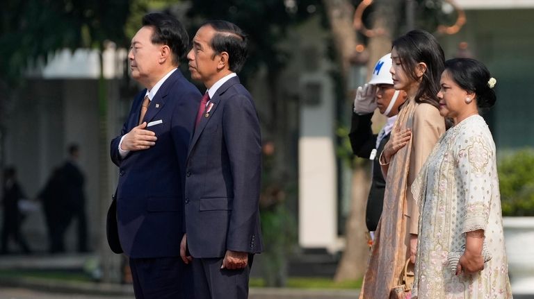 South Korean President Yoon Suk Yeol, left, and his wife...