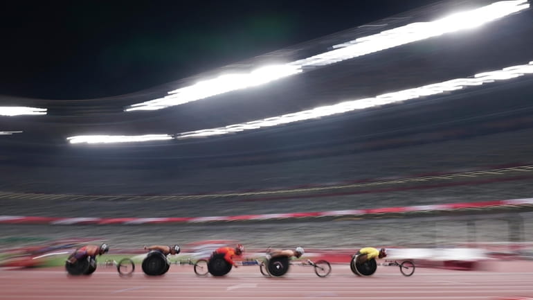 Athletes compete during men's T54 5000m heat at Tokyo 2020...