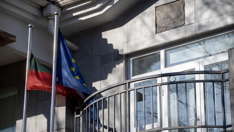 Lithuanian and European Union flags fly outside the Lithuanian Embassy...