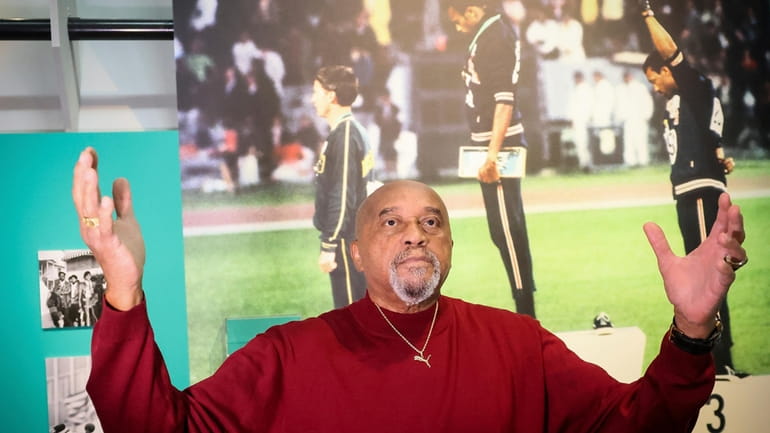 American former track and field athlete Tommie Smith gestures in...