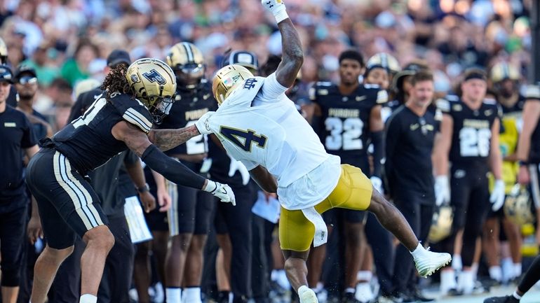 Purdue defensive back Antonio Stevens (11) tackles Notre Dame running...