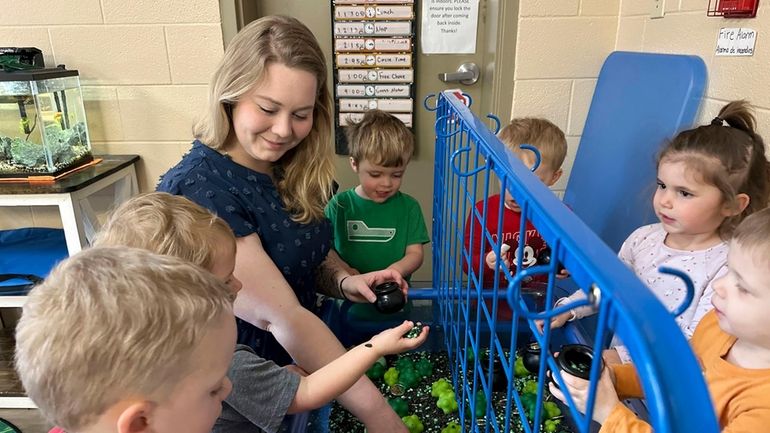 Rylee Monn plays with children in her class at a...