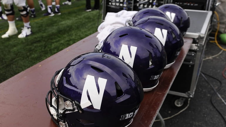 Northwestern helmets sit on a table during an NCAA college...