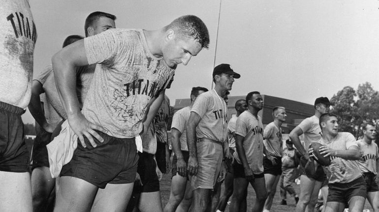 Former quarterback Sammy Baugh, with cap, now coach of the...