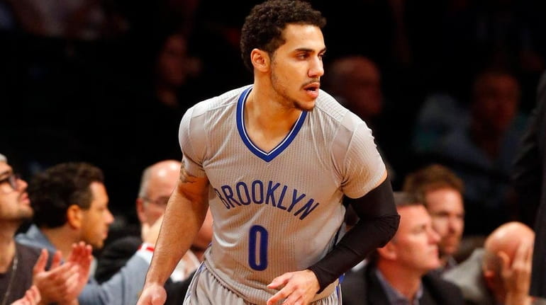 Shane Larkin of the Brooklyn Nets reacts after a three-point...