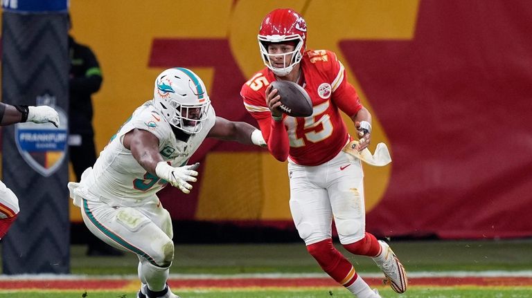 Kansas City Chiefs quarterback Patrick Mahomes (15) scrambles away from...