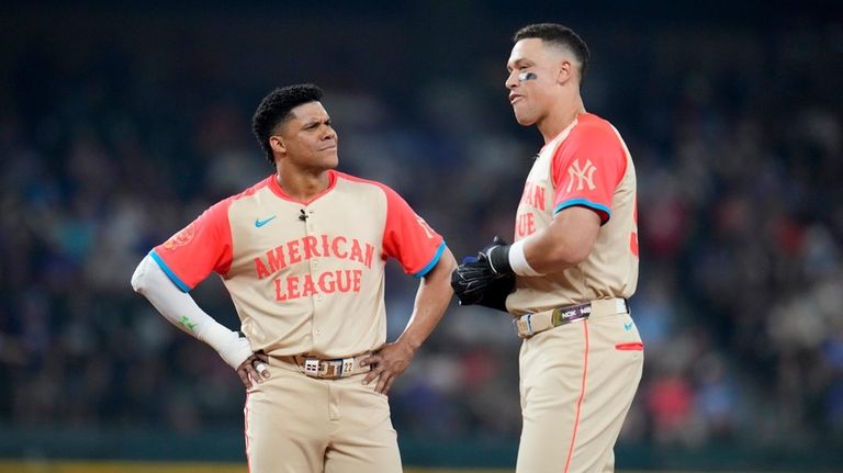 The Yankees' Juan Soto, left, talks to teammate Aaron Judge...