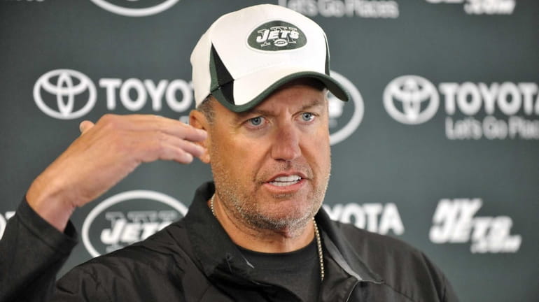 Rex Ryan talks to reporters during training camp in Cortland....