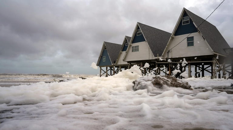 Winds from Tropical Storm Alberto blow sea foam inland, Wednesday,...