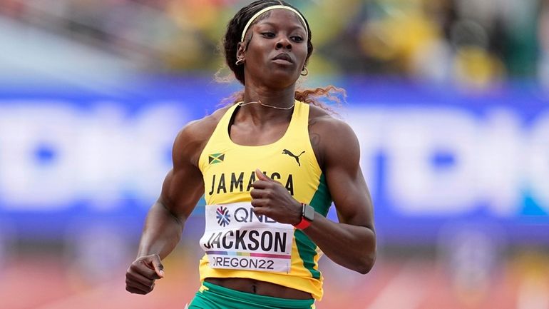 Shericka Jackson, of Jamaica, wins a heat in the women's...