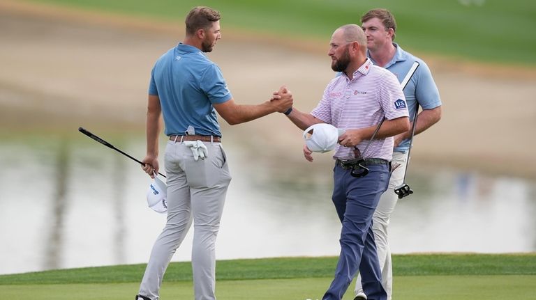 Sam Burns, left, shakes hands with Erik Barnes on the...