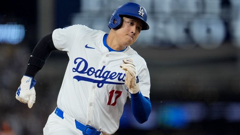 Los Angeles Dodgers' Shohei Ohtani runs rounds third base to...