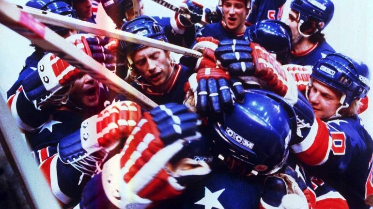 Team USA members congratulate each other on the ice during...