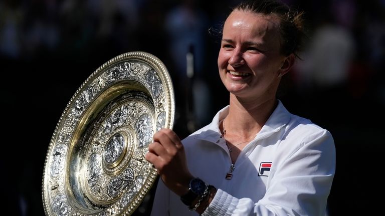 Barbora Krejcikova of the Czech Republic holds up the winners...