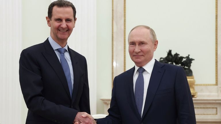 Syrian President Bashar Assad, left, and Russian President Vladimir Putin...