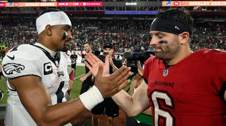 Philadelphia Eagles' Jalen Hurts, left, and Tampa Bay Buccaneers' Baker...