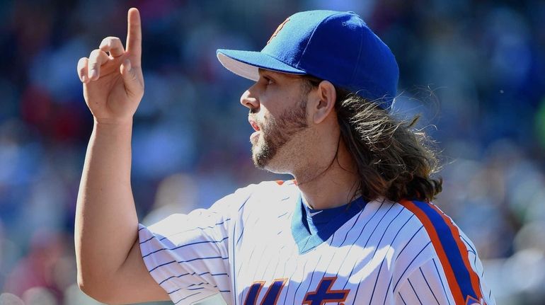 New York Mets starting pitcher Robert Gsellman reacts against the...