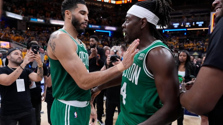 Boston Celtics forward Jayson Tatum, left, celebrates with teammate guard...