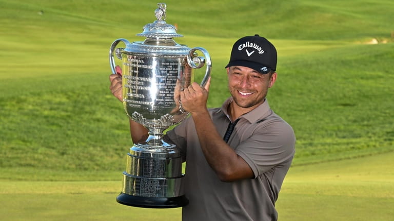 Xander Schauffele holds the Wanamaker trophy after winning the PGA...