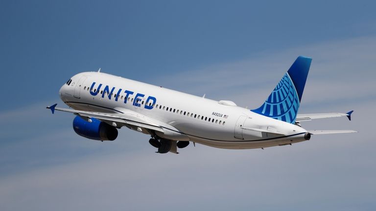 A United Airlines jetliner lifts off from a runway at...