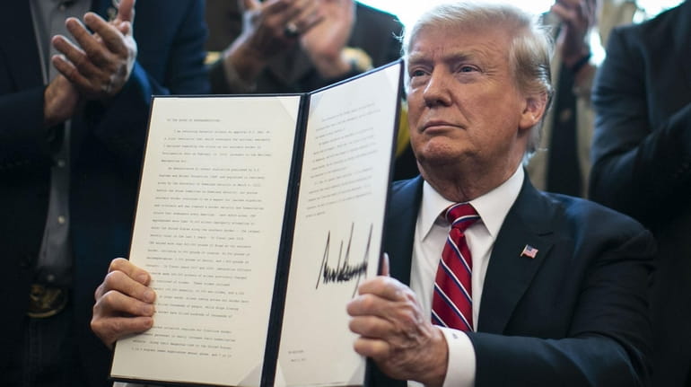President Donald Trump with his signed veto in the Oval Office...