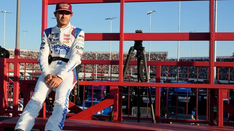 Kyle Larson waits for an interview after arriving for the...