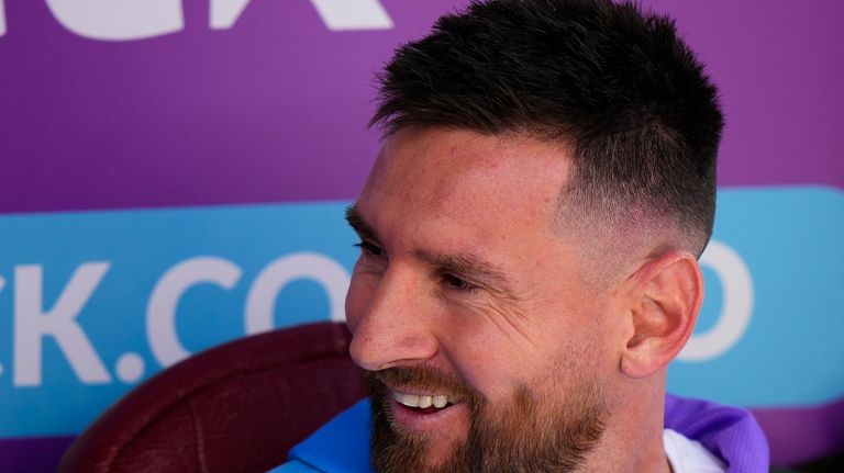 Argentina's Lionel Messi sits on the bench during a qualifying...